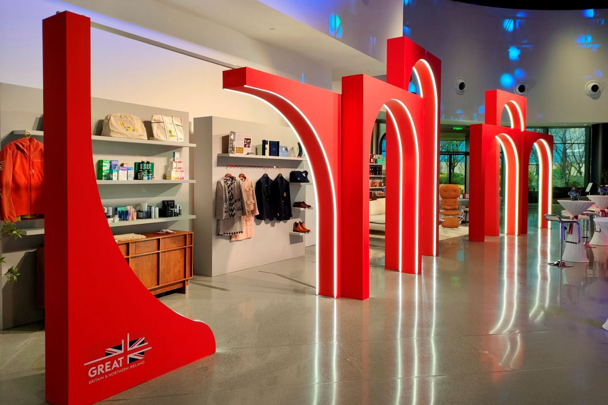 Red arches frame the different product displays in a flagship store design-like experience;
Image Source: 5 Star Plus Retail Design